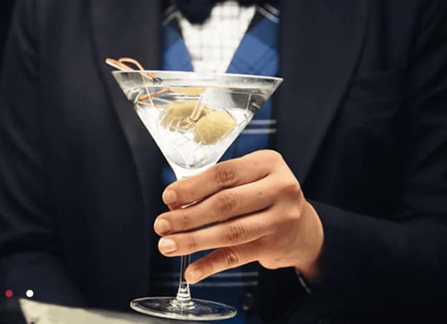 Hand holding a martini glass