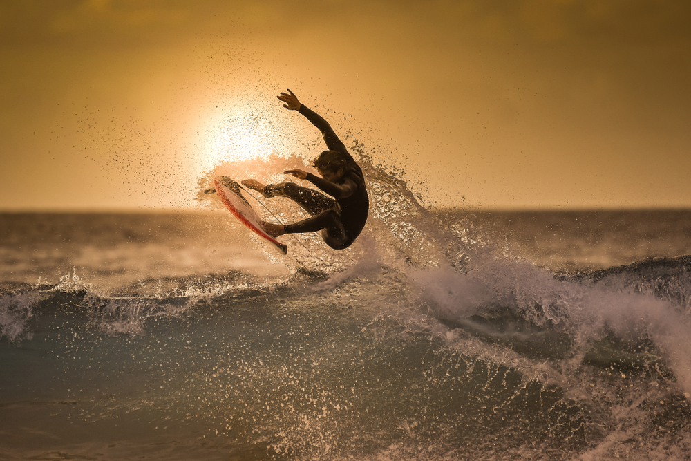 olympic surfer at sunset